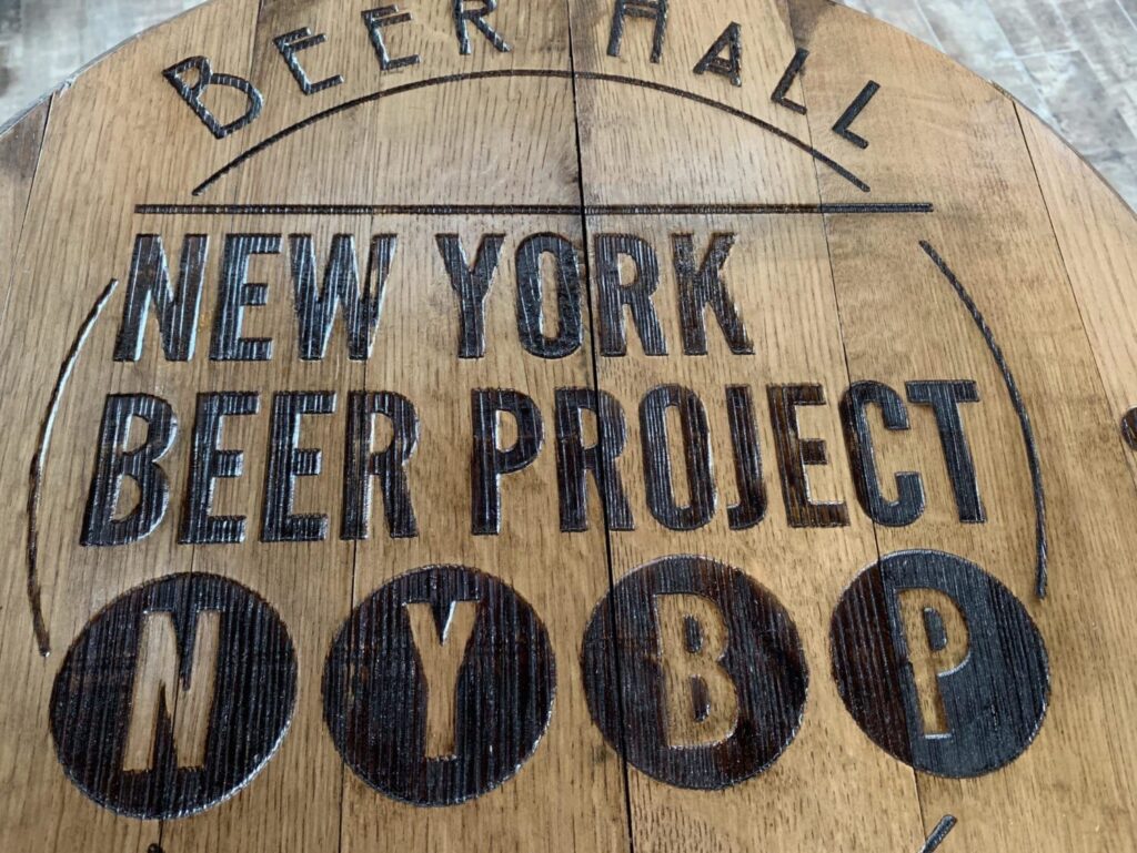 A wooden sign for the new york beer project.