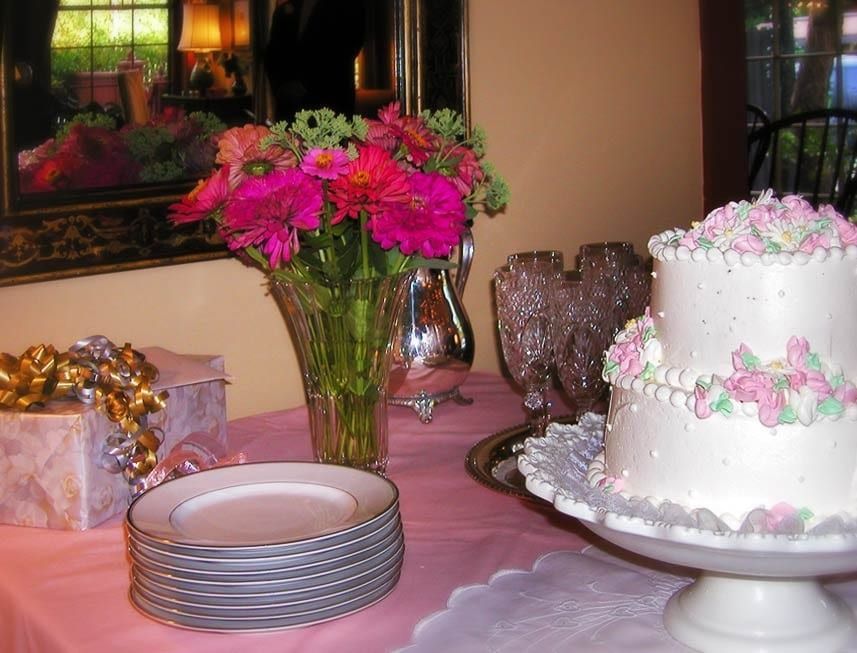 A table with plates and a cake on it.