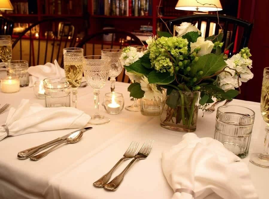 A table with a vase of flowers on it.